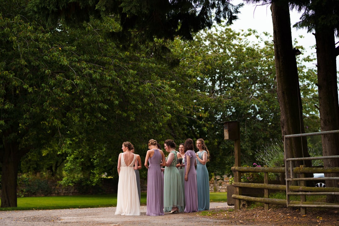 bridesmaids and bride wait patiently for the ceremony to start