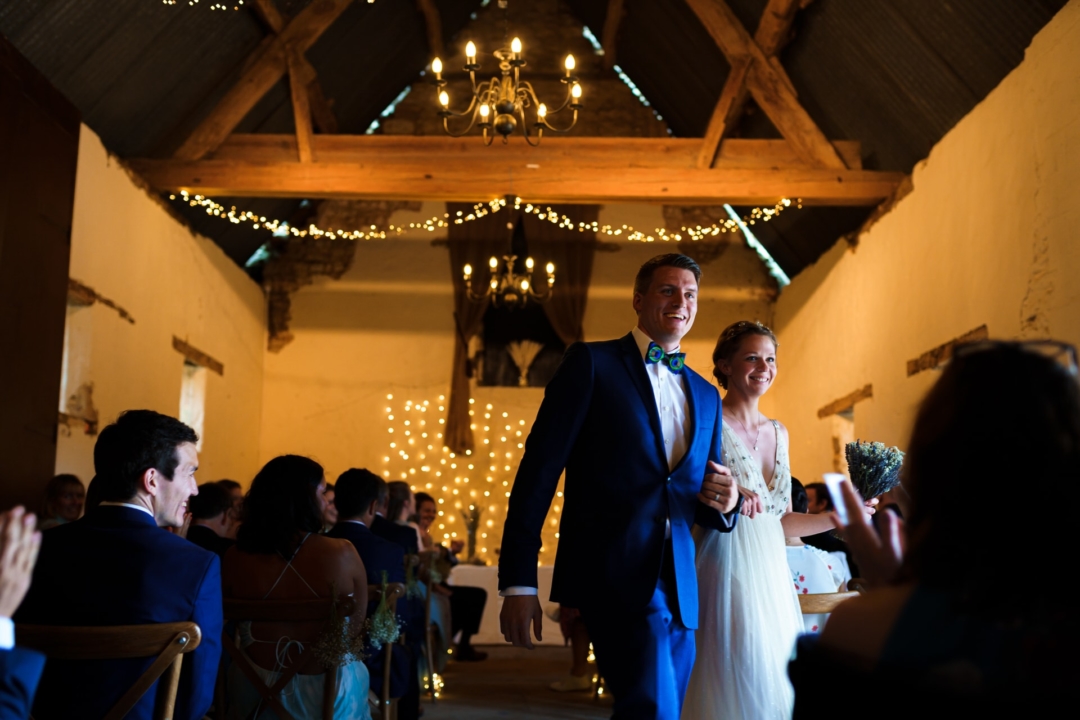 Bride and Groom leave their wedding ceremony at Slapton Manor