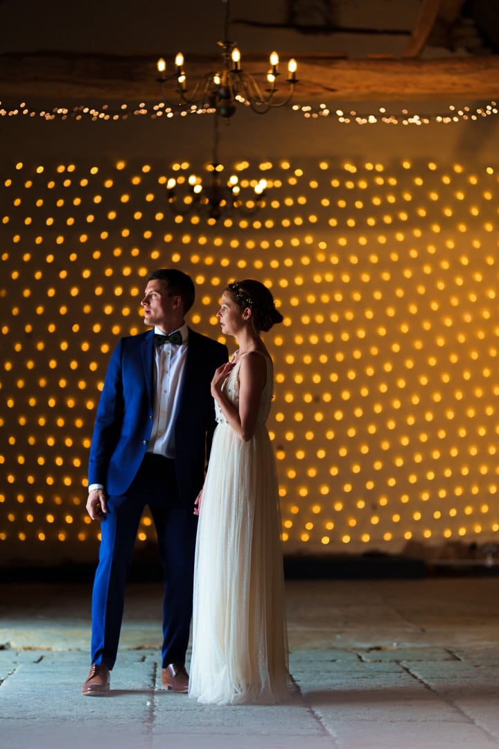 bride and groom inside the threshing barn with rustic lighting
