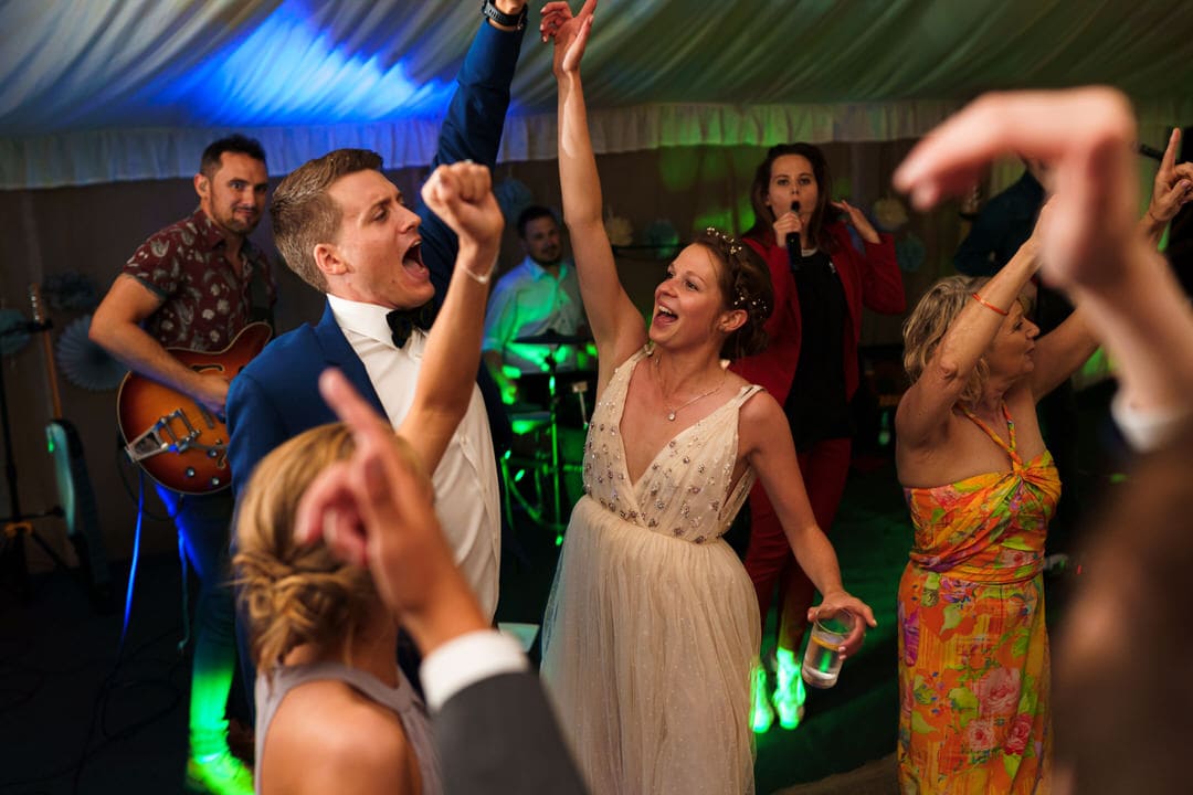 bride and groom dance inside the marquee