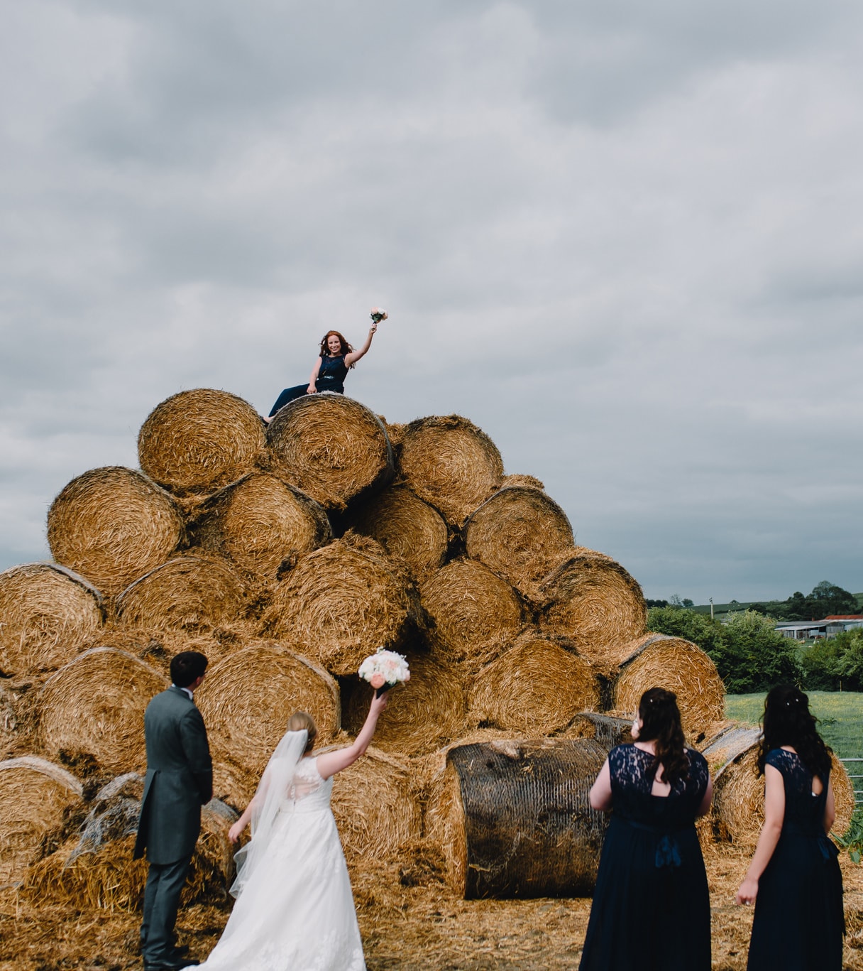 bridesmaid-on-hay-bails-wood-farm